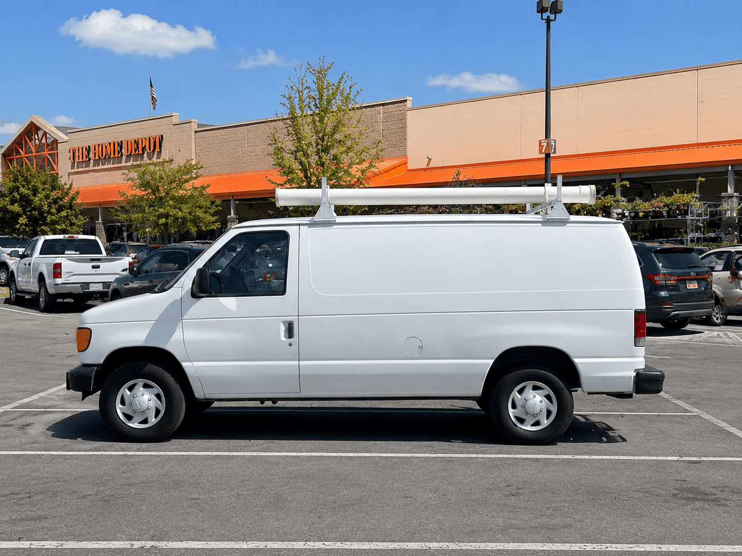 Plain white Ford Econoline van before the AC Volt wrap